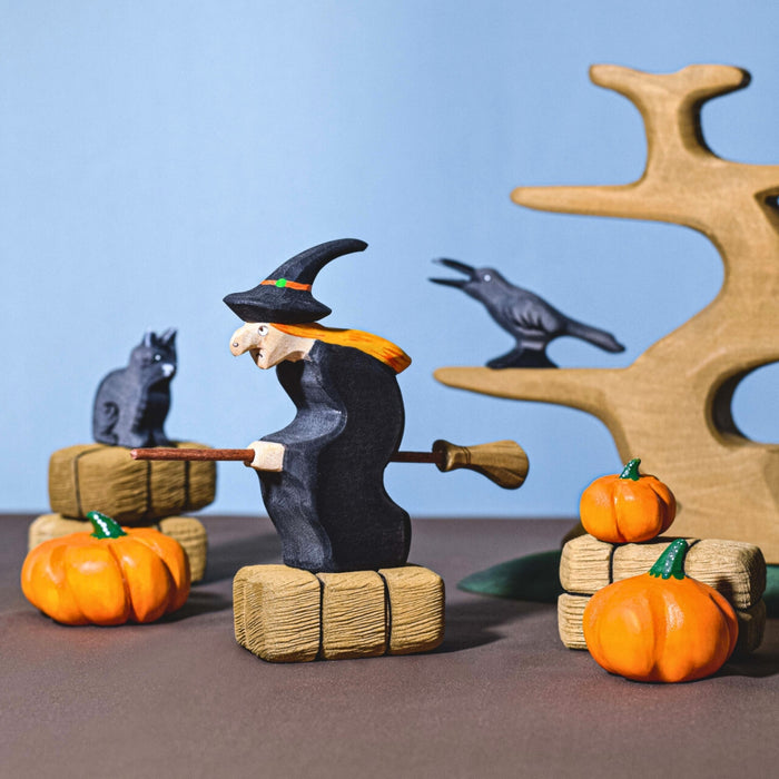 BumbuToys Handcrafted Wooden Witch Figure from Australia in a small-world play setting
