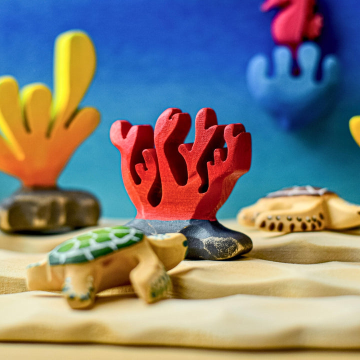 BumbuToys Handcrafted Wooden Figure Red Coral from Australia in an ocean small-world play setting