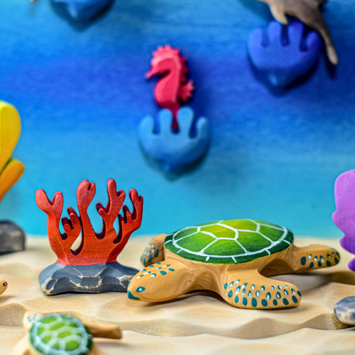 BumbuToys Handcrafted Wooden Figure Red Coral from Australia in an ocean small-world play setting