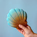 BumbuToys Handcrafted Closed Large Shell Wooden Toy from Australia on an adult person's hand