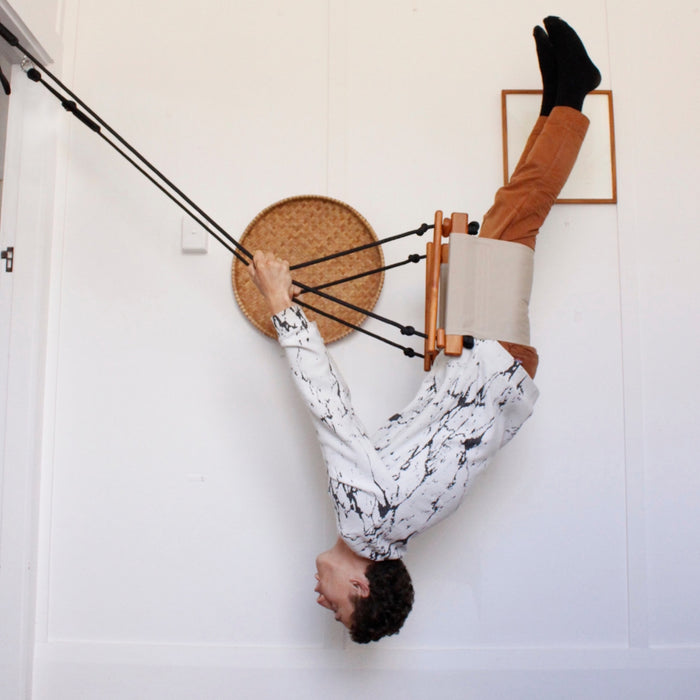 A man doing a play swing flip trick indoors using a SOLVEJ Adult & Child Swing Soft Linen Colour from Australia