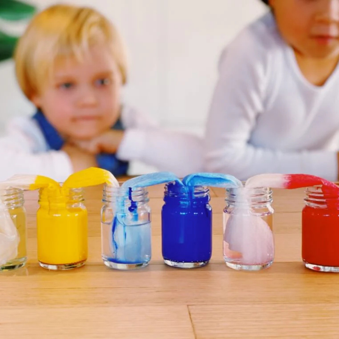 Children exploring colour mixing and capillary action with walking rainbow STEM activity
