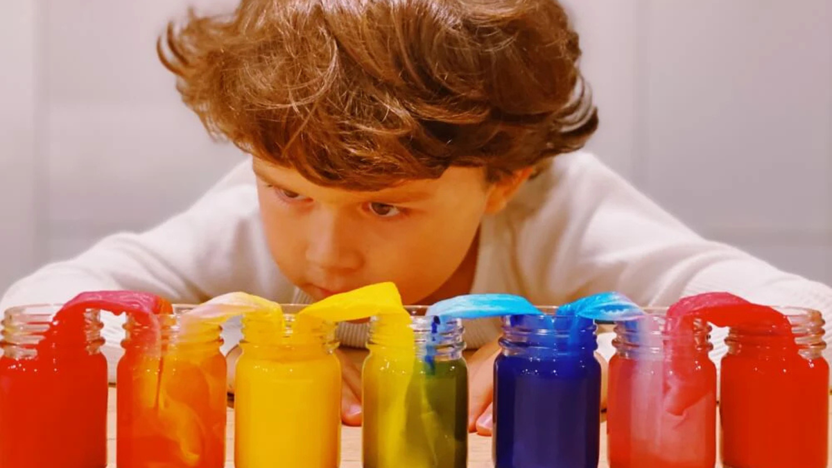 Walking rainbow experiment setup with 7 jars, paper towels and watercolour paints