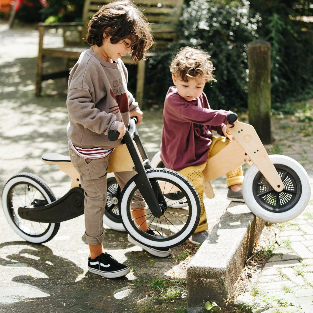 Wishbone Balance Bike Original and Recycled Edition with two boys riding in Australia